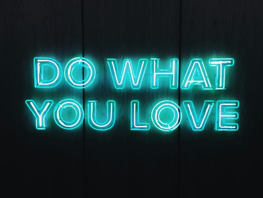 "do what you love" written by a blue neon sign