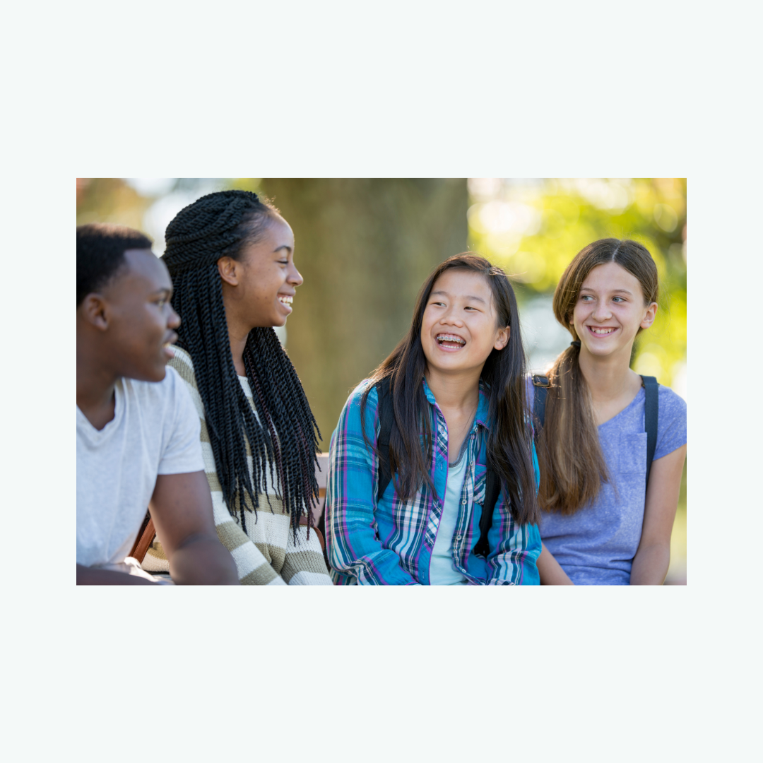 Four teens smiling and hanging out