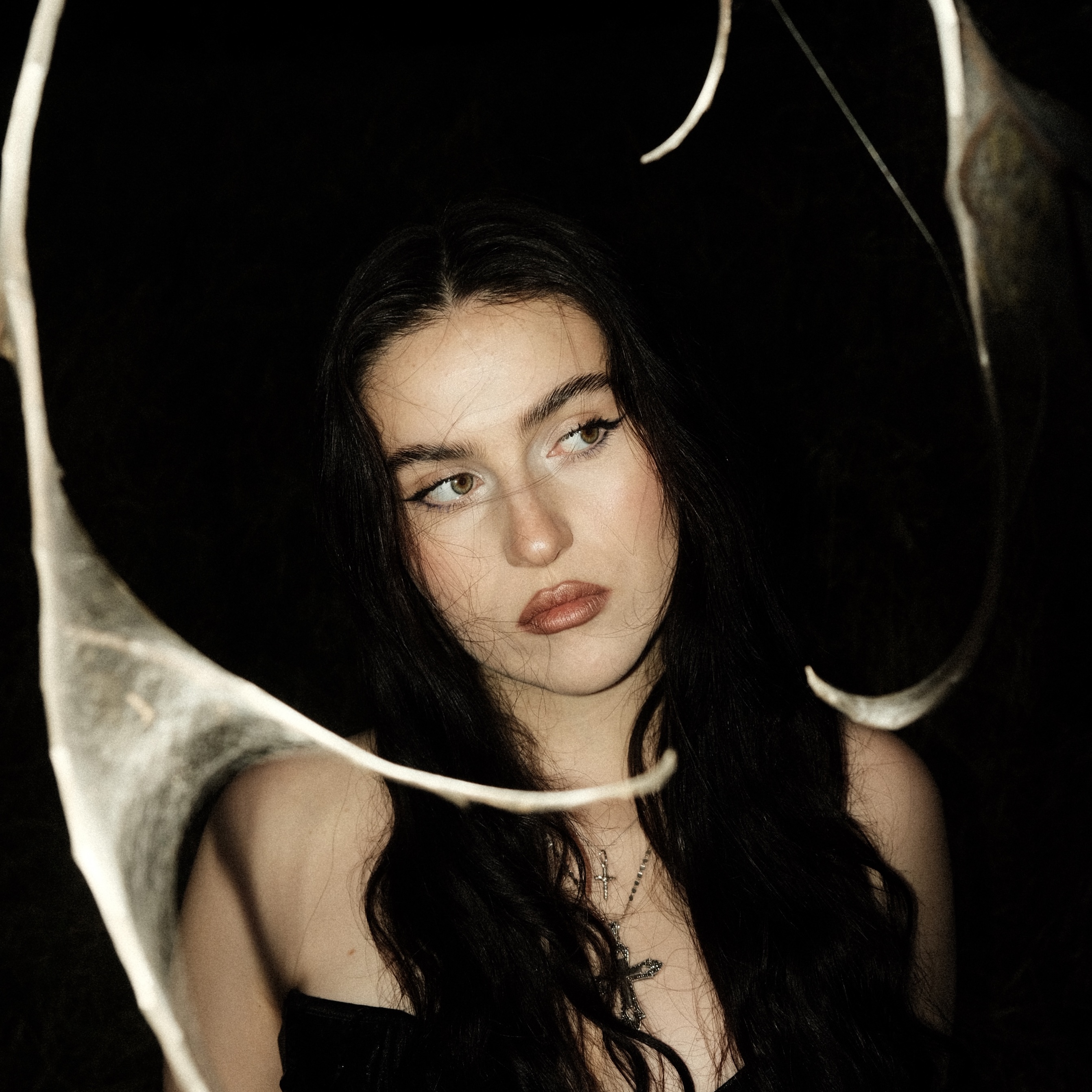 TÉODORA looking into the camera with a black background