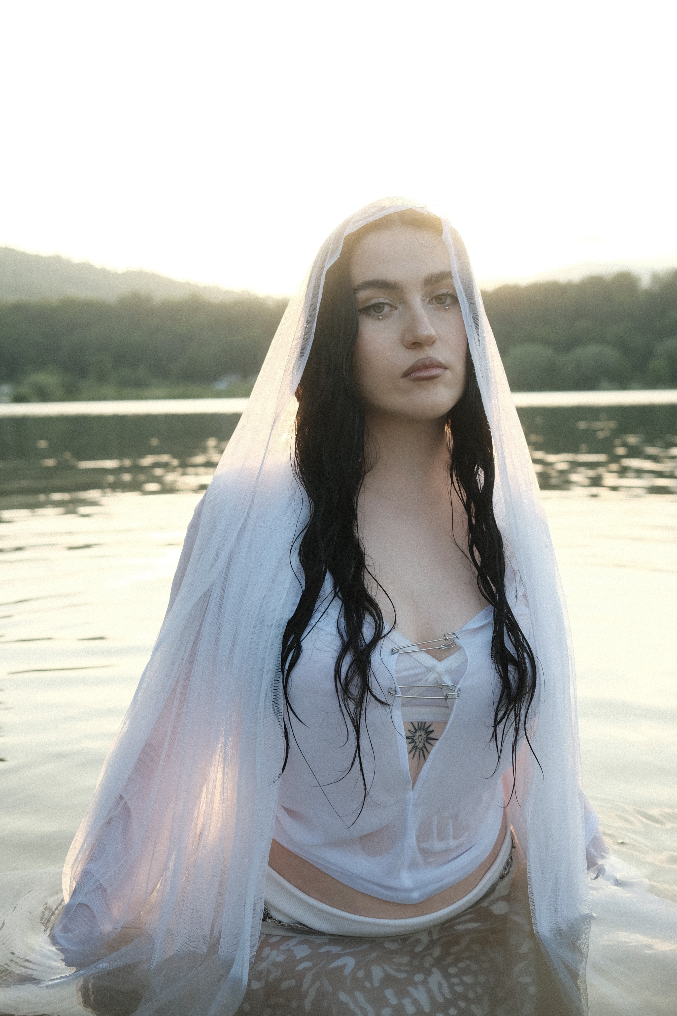 TÉODORA standing in water wearing all white