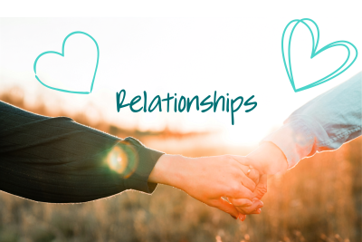 Holding hands against a sunset field backdrop. Above are two blue heart graphics.