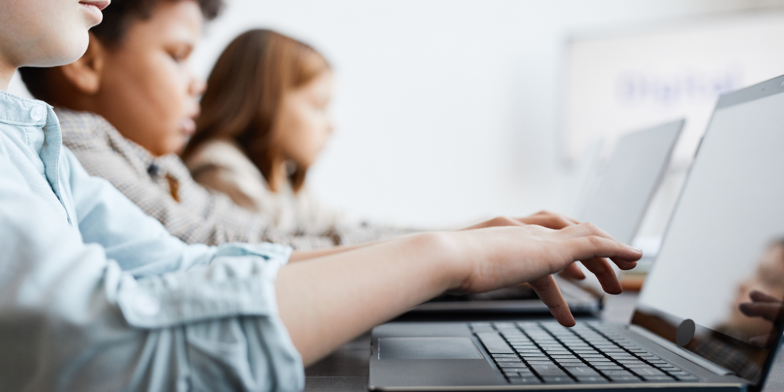 Kids using computers in school