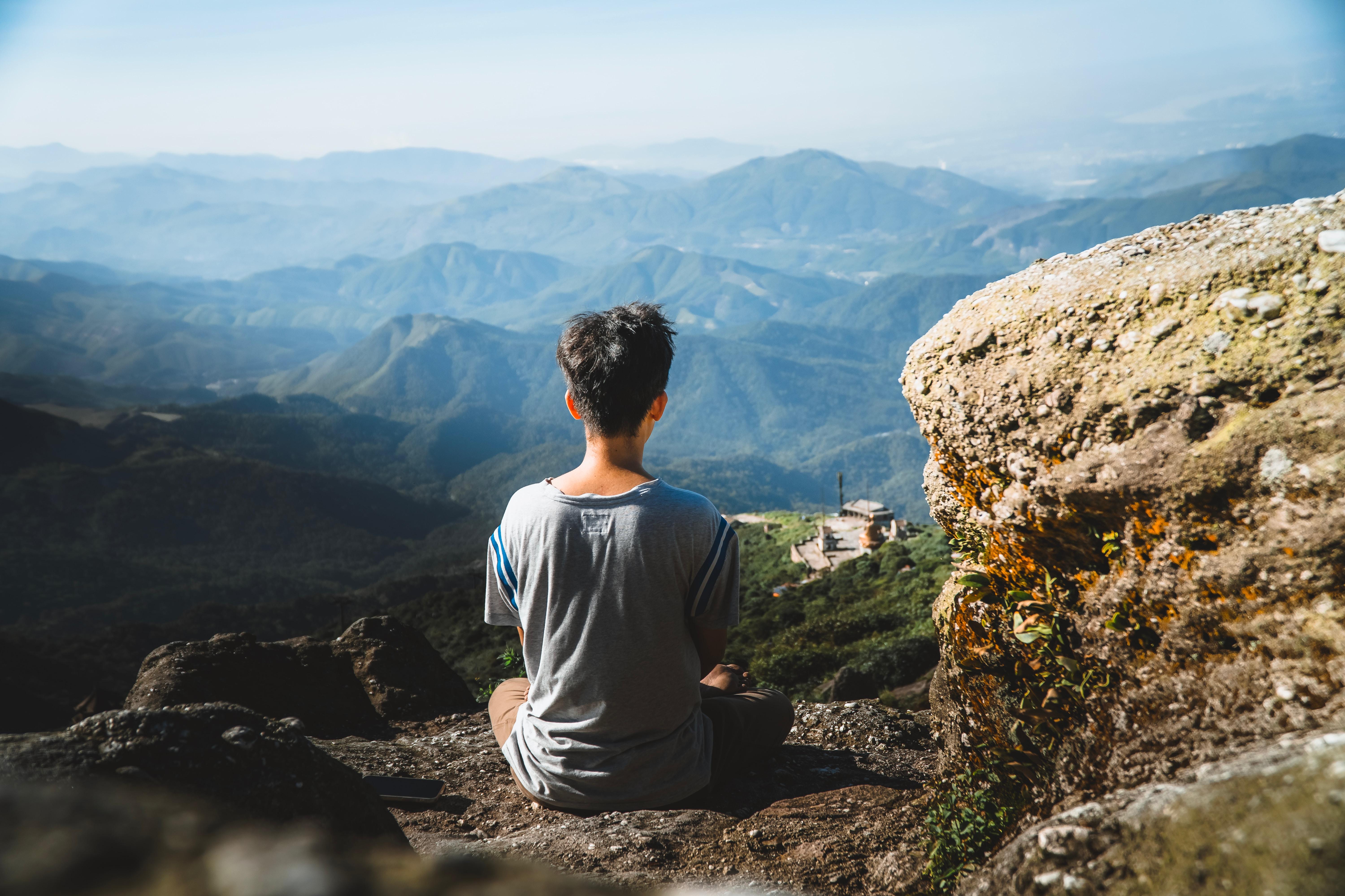 man sitting overlooking the mountains