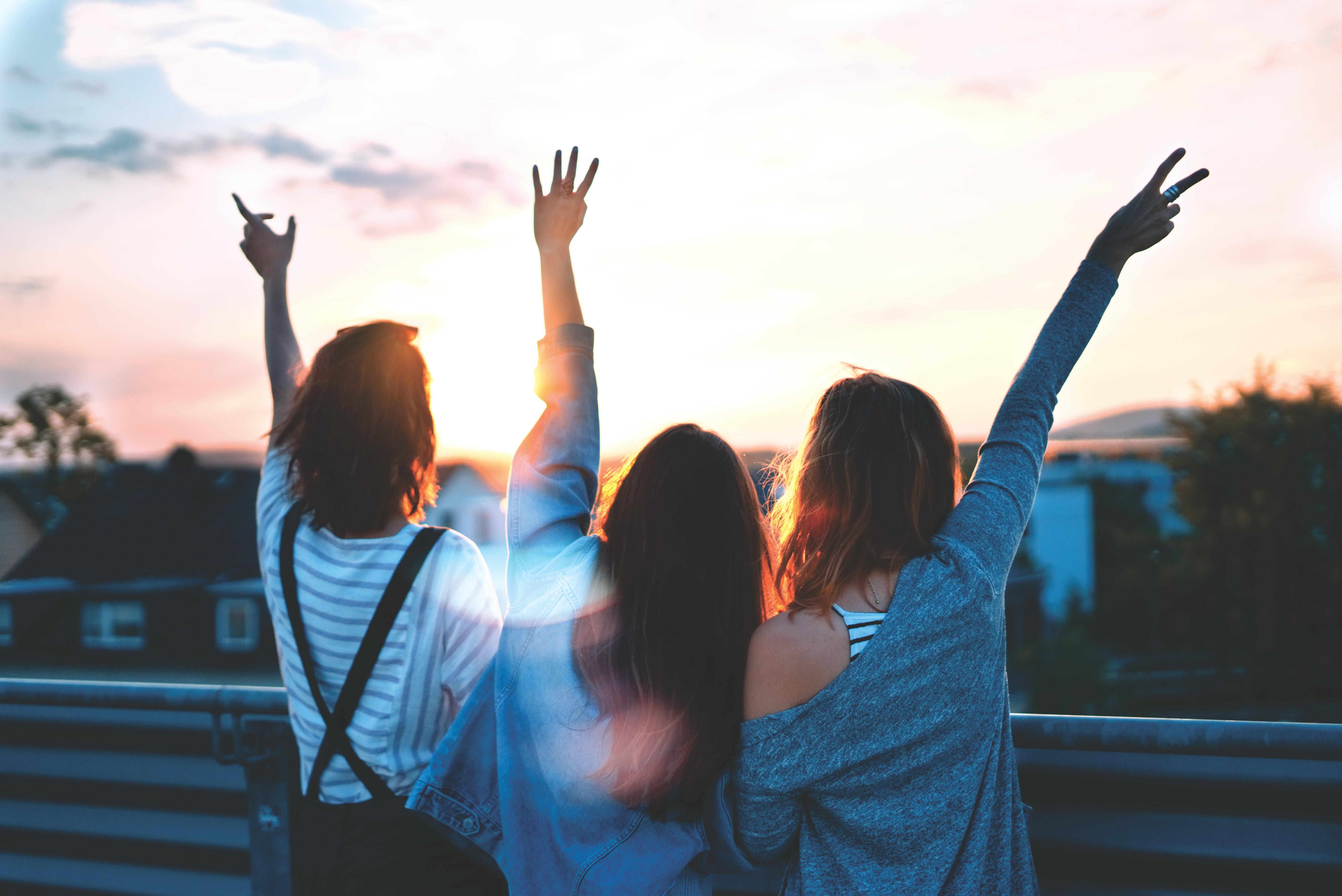 3 girls looking out over the sunset