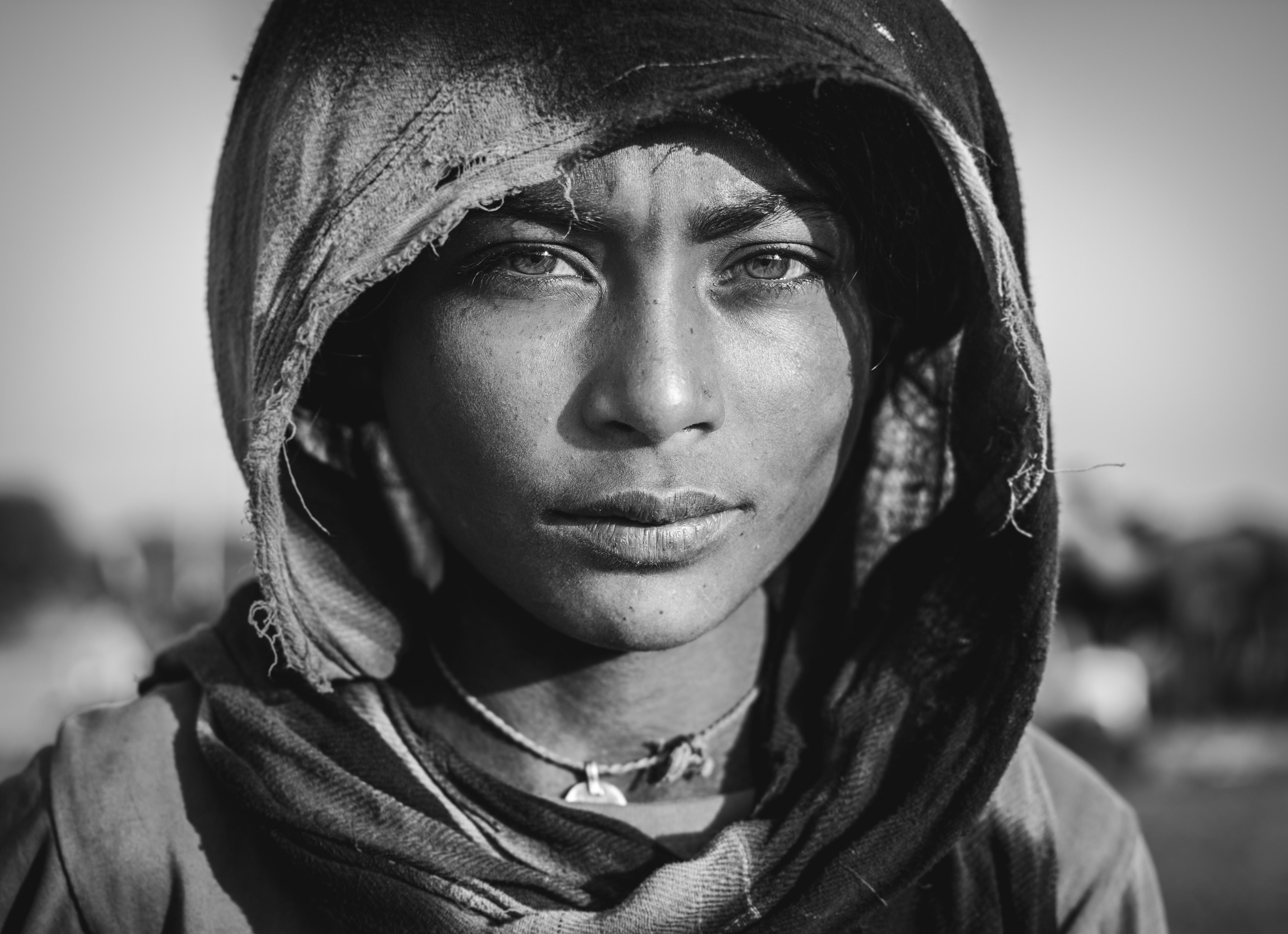 Grayscale photo of a woman looking into a the camera