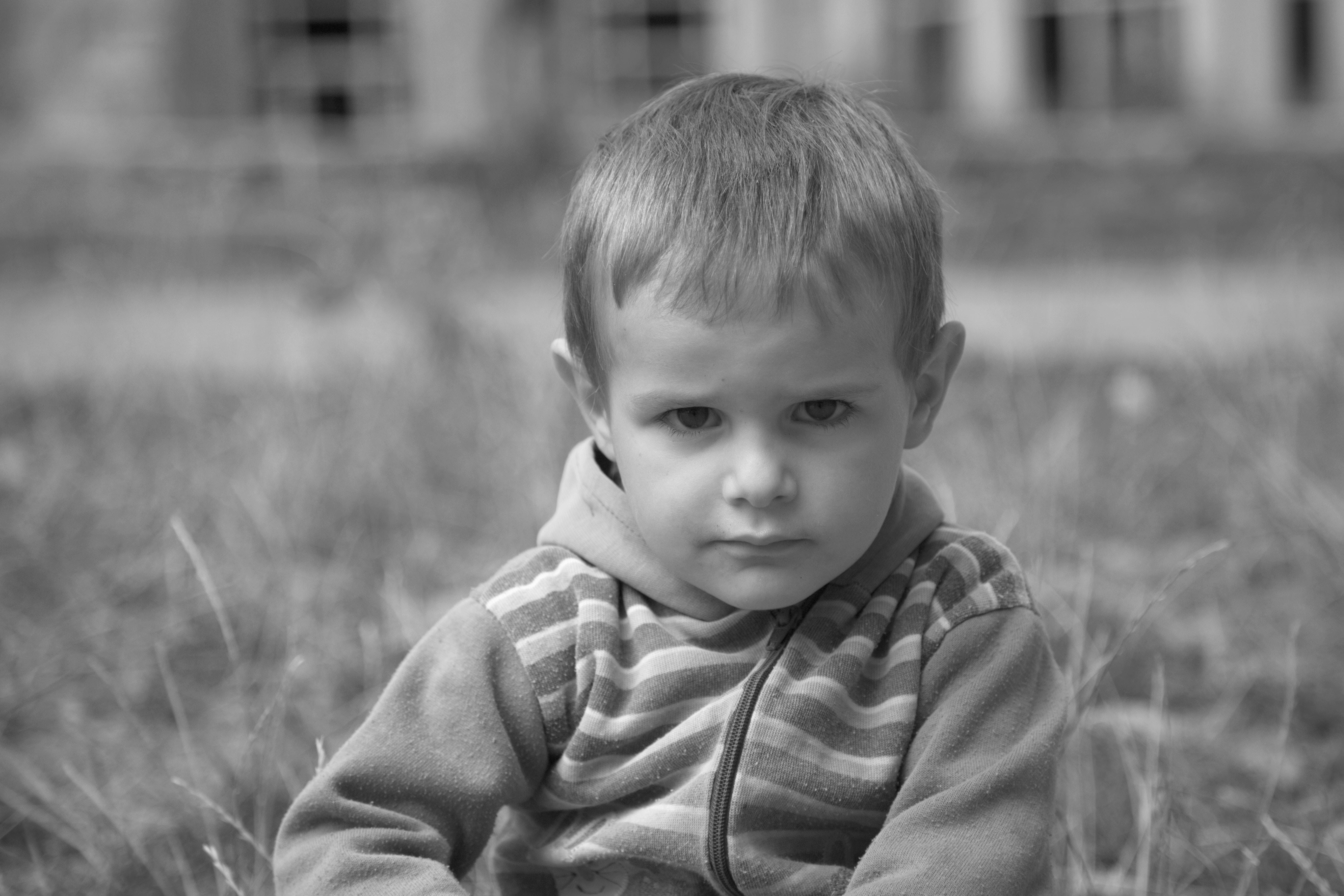 gray scale photo of a little boy pouting