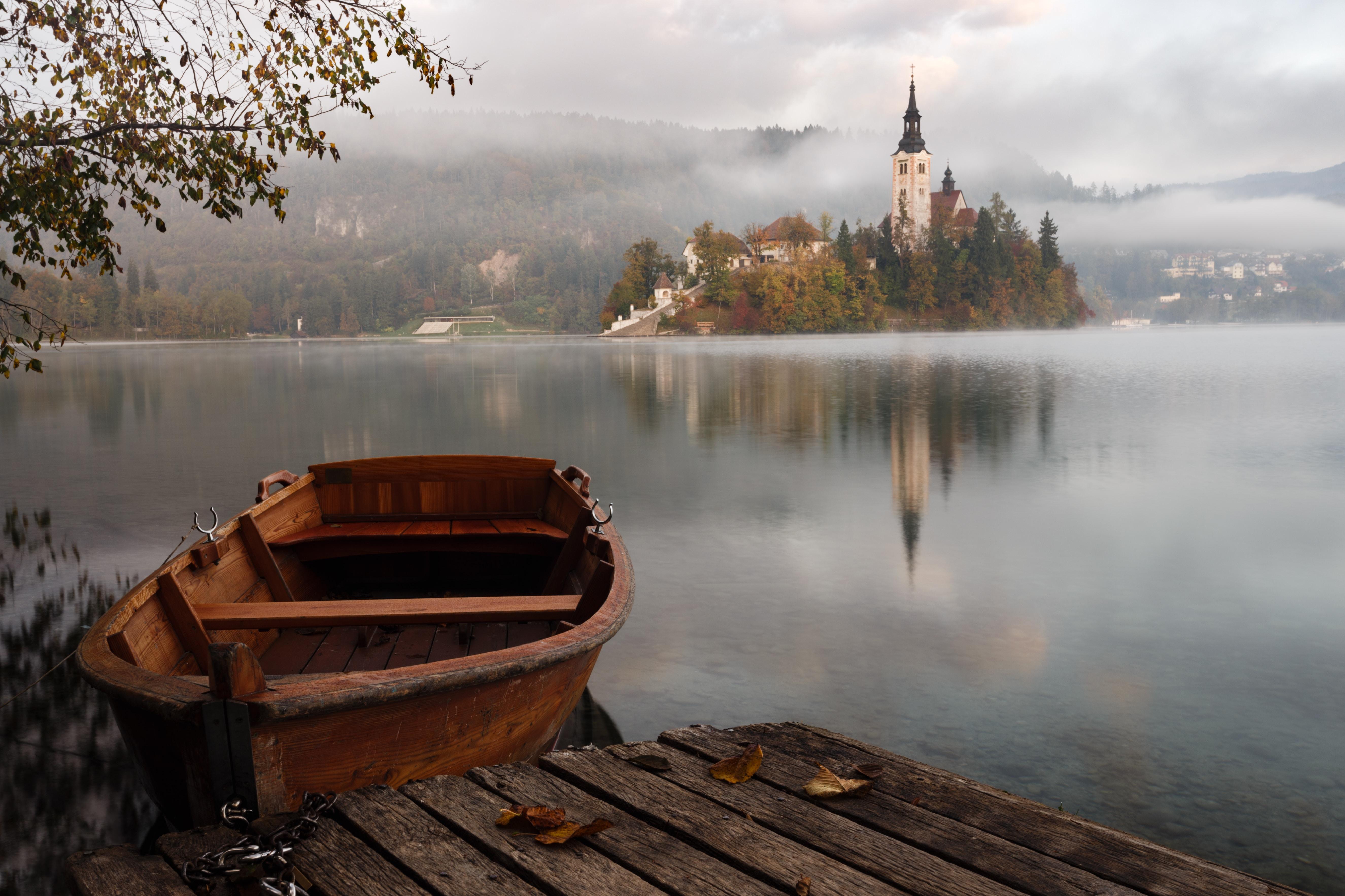 a boat on the water with a castle in the background