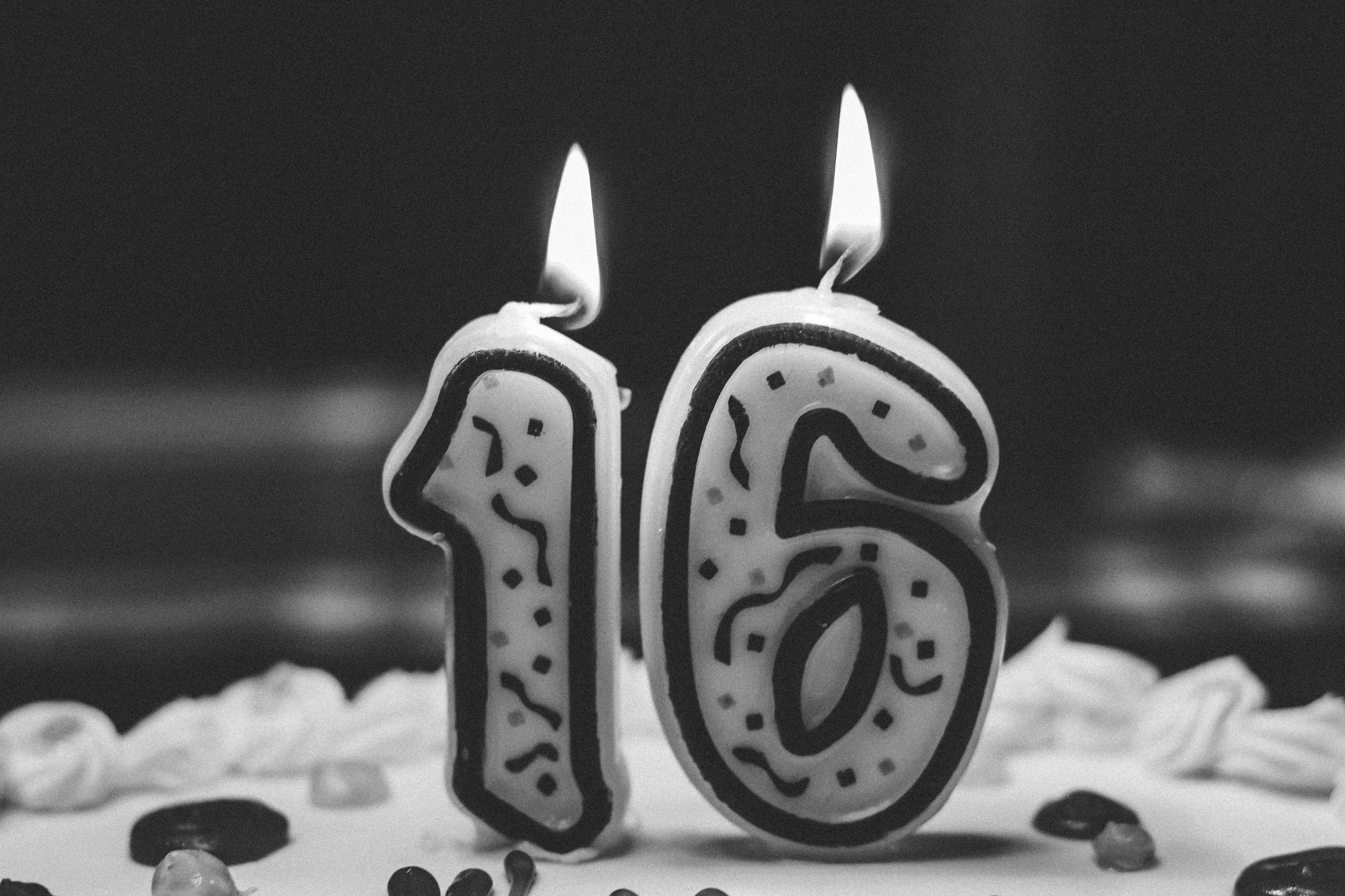 candles in the shape of a "16" on the top of a cake