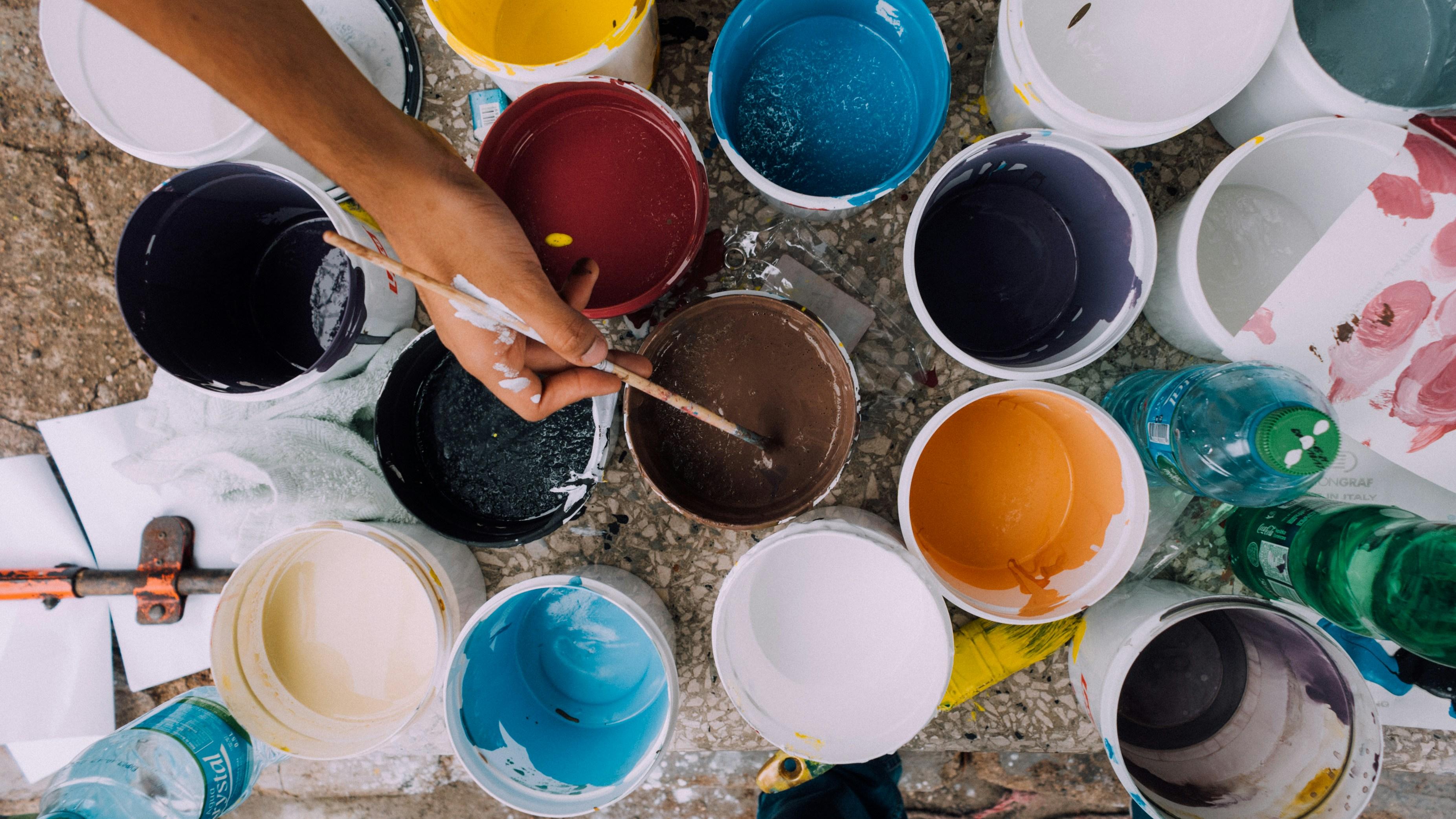 person dipping into some paint