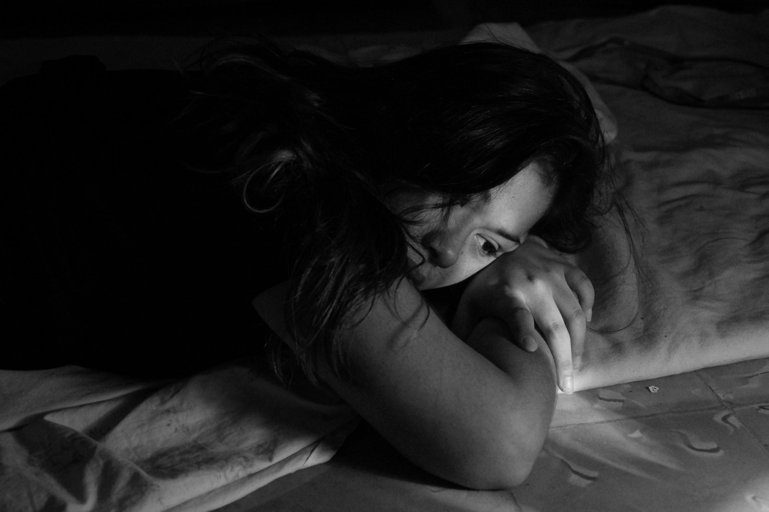 black and white image of a young woman lying down