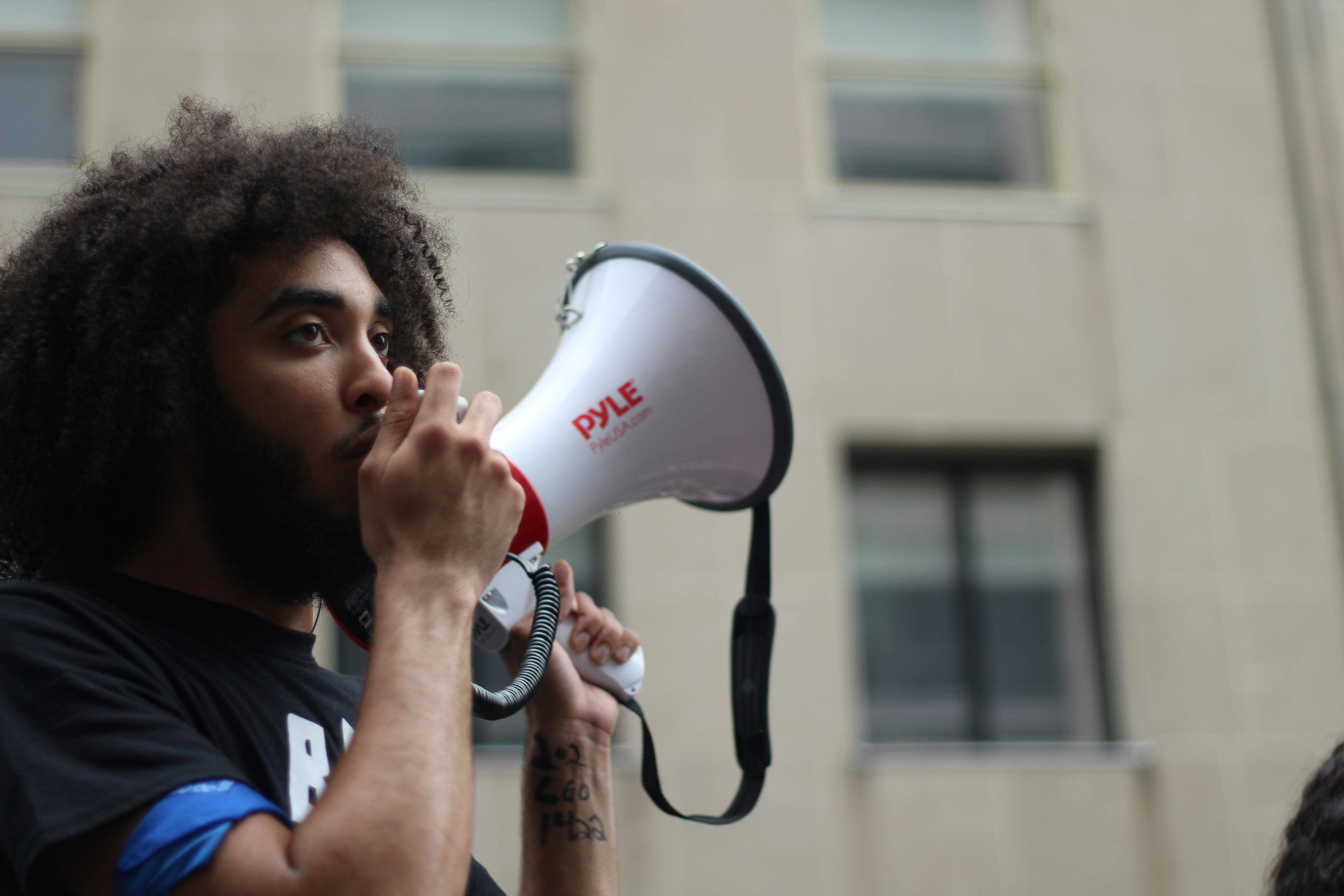 a young person talking into a megaphone