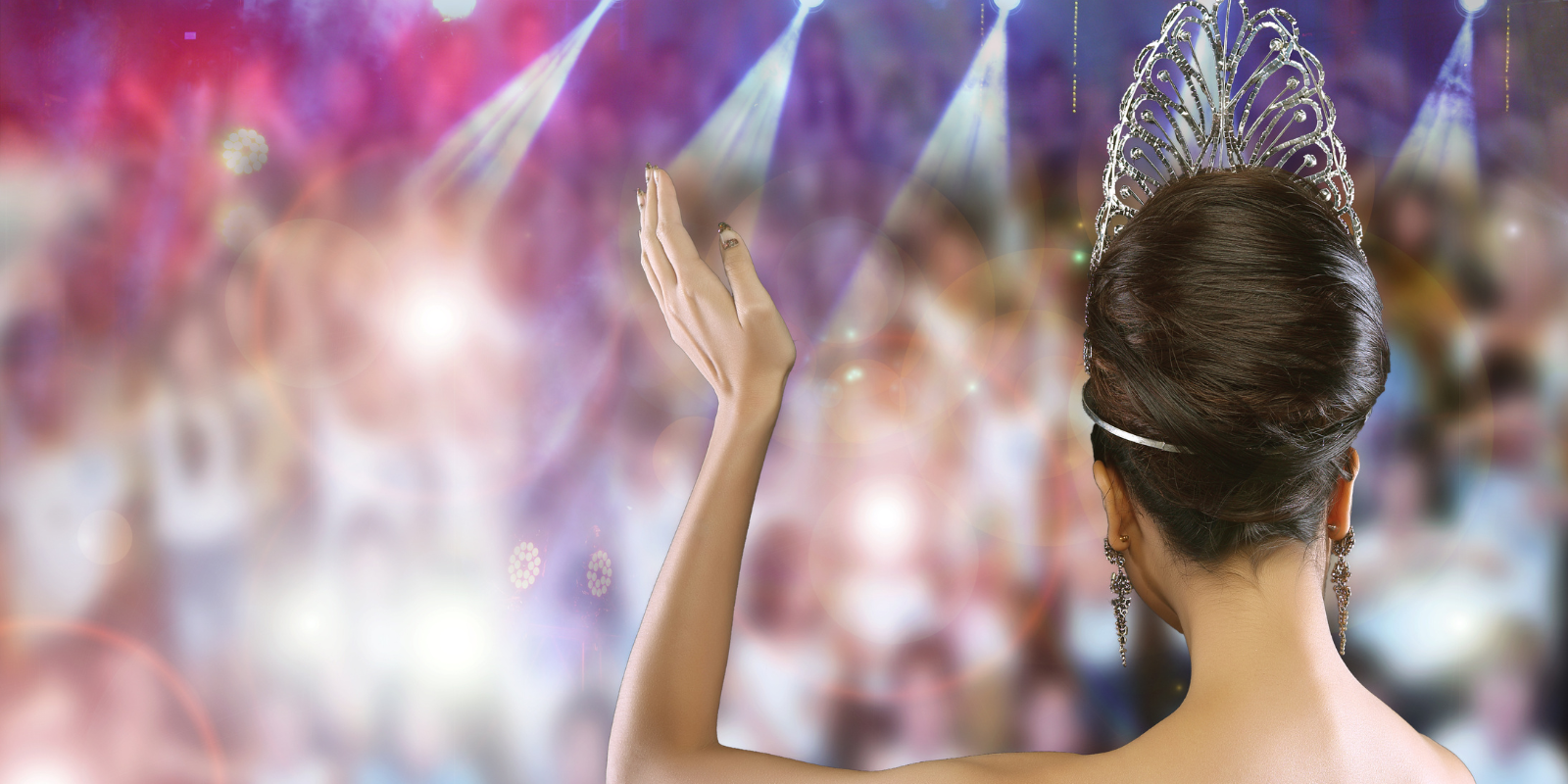 the back of a woman waving at a beauty pageant