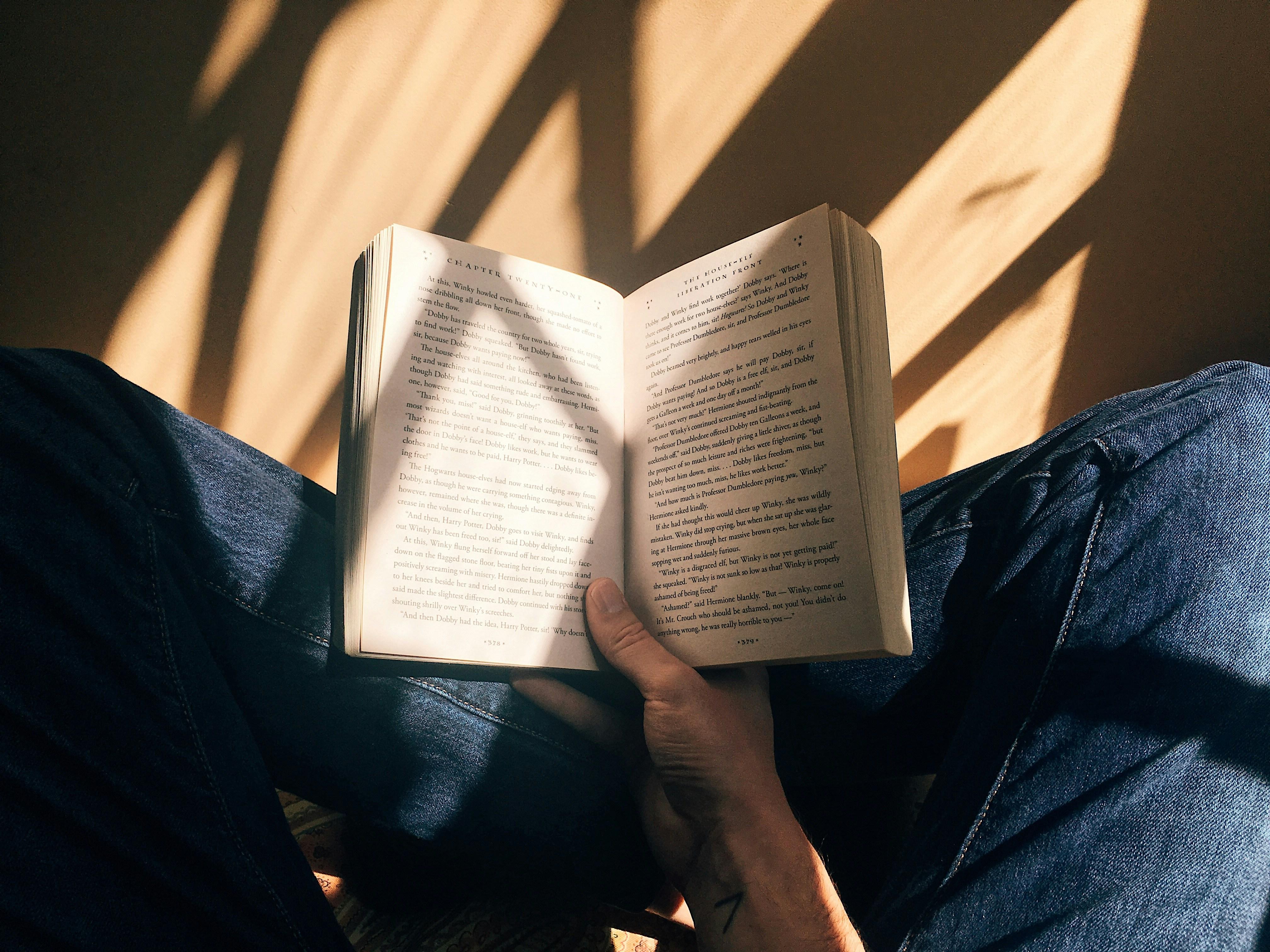 person sitting reading a book