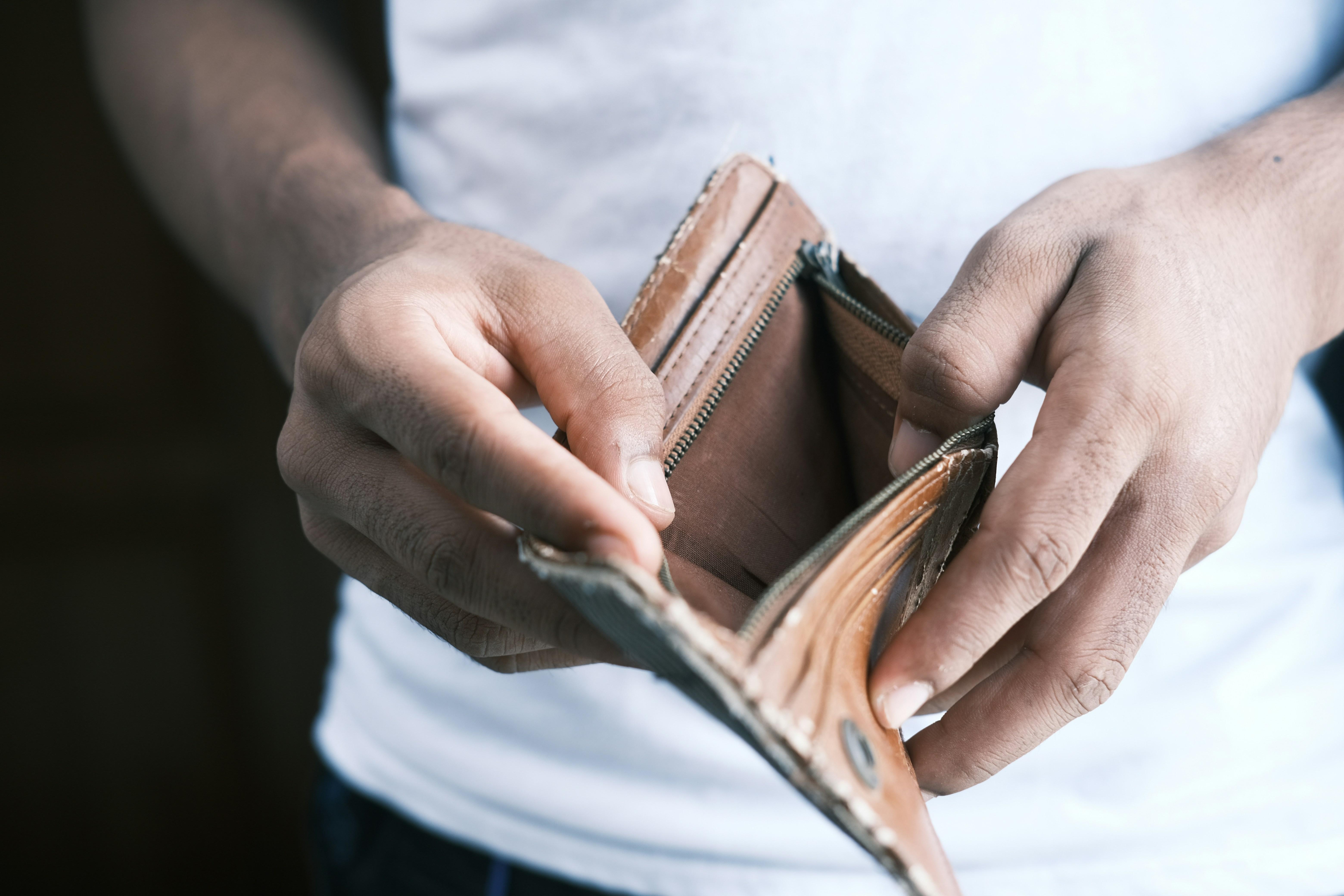person holding open an empty wallet