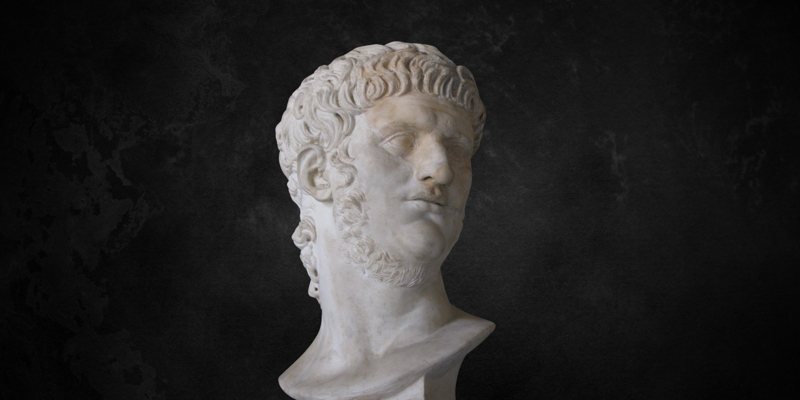 A bust of emperor Nero on a black background