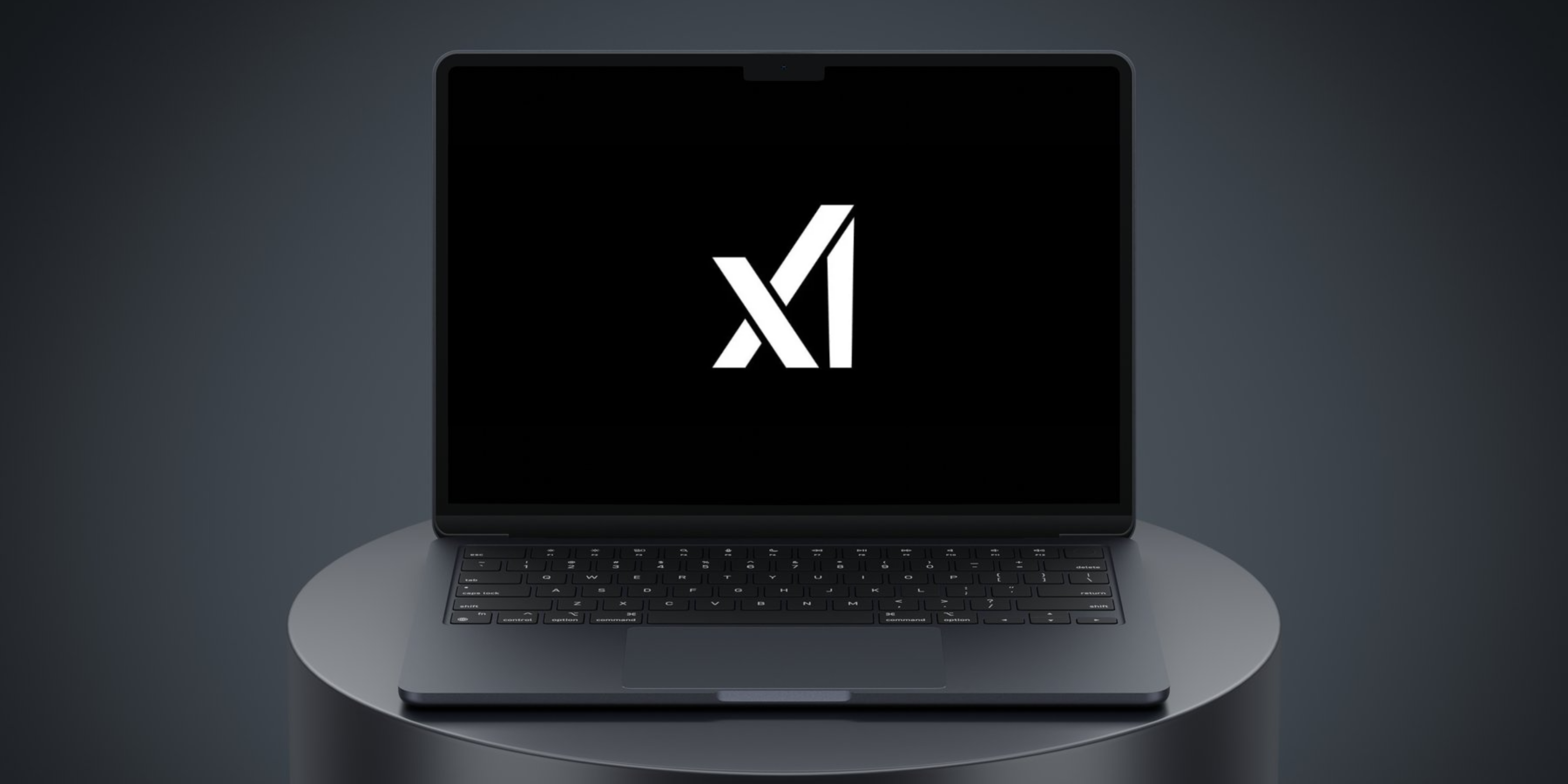 the X Ai logo on a black laptop 