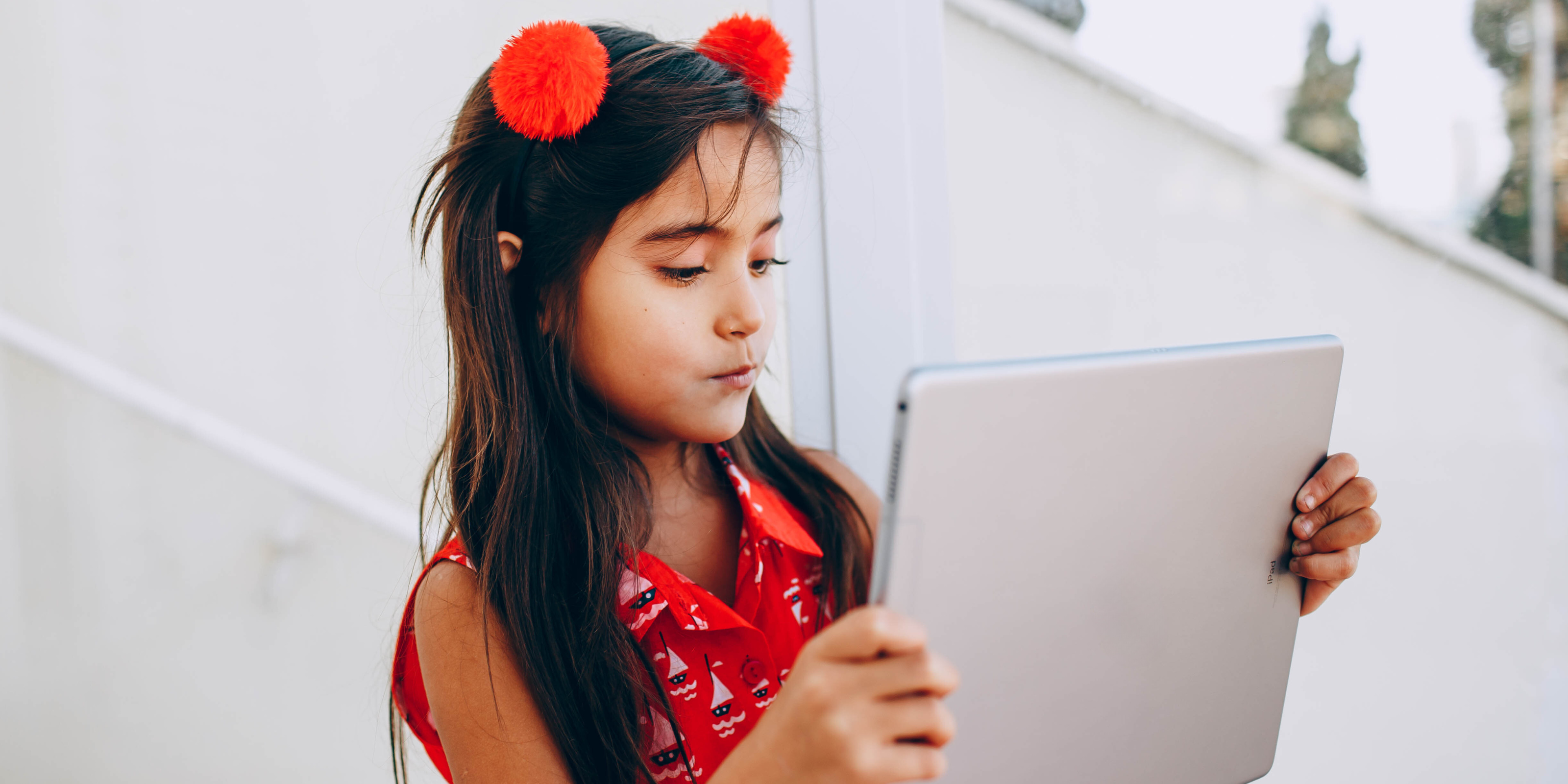 young girl looking at a tablet screen