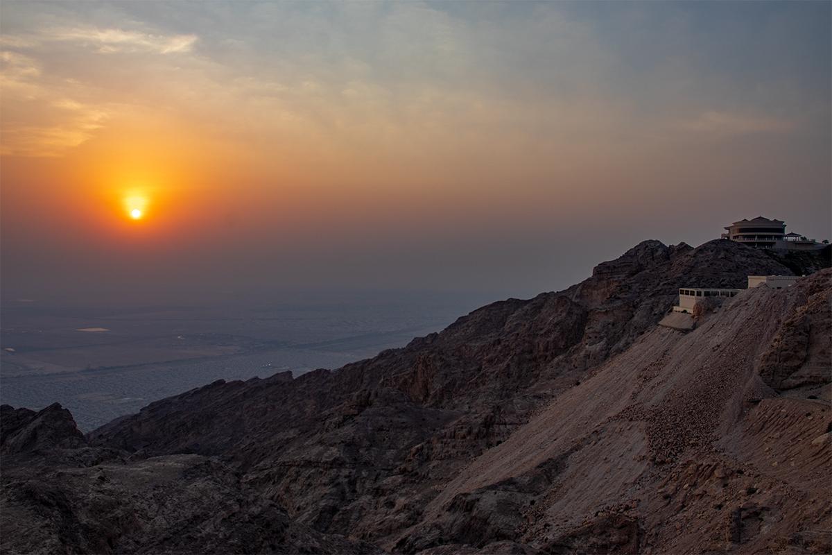 shot of the sun setting beside Jebel Hafeet