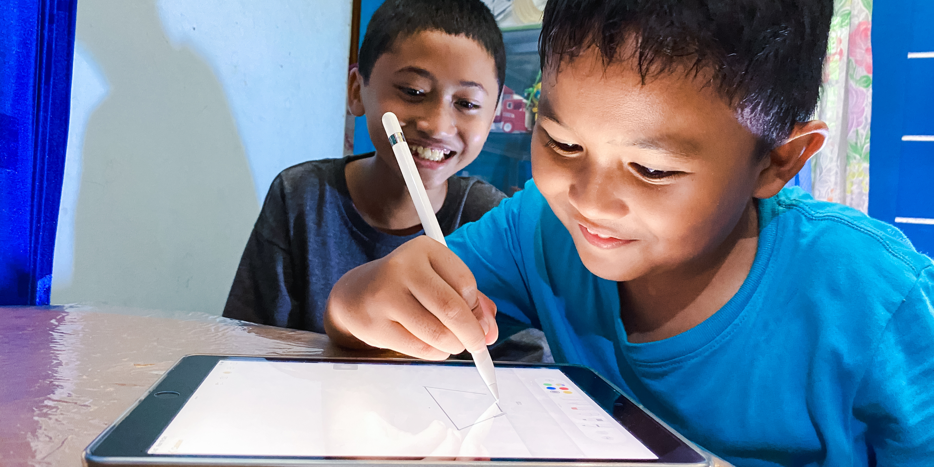 boys using ipad tablet to write and draw