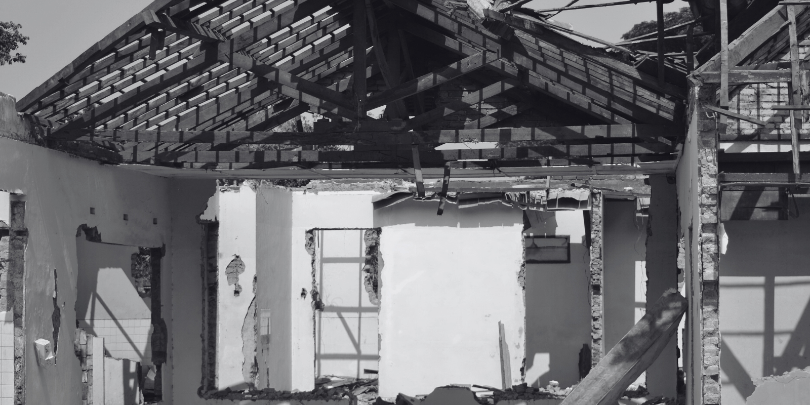 a black and white photo of a destroyed house