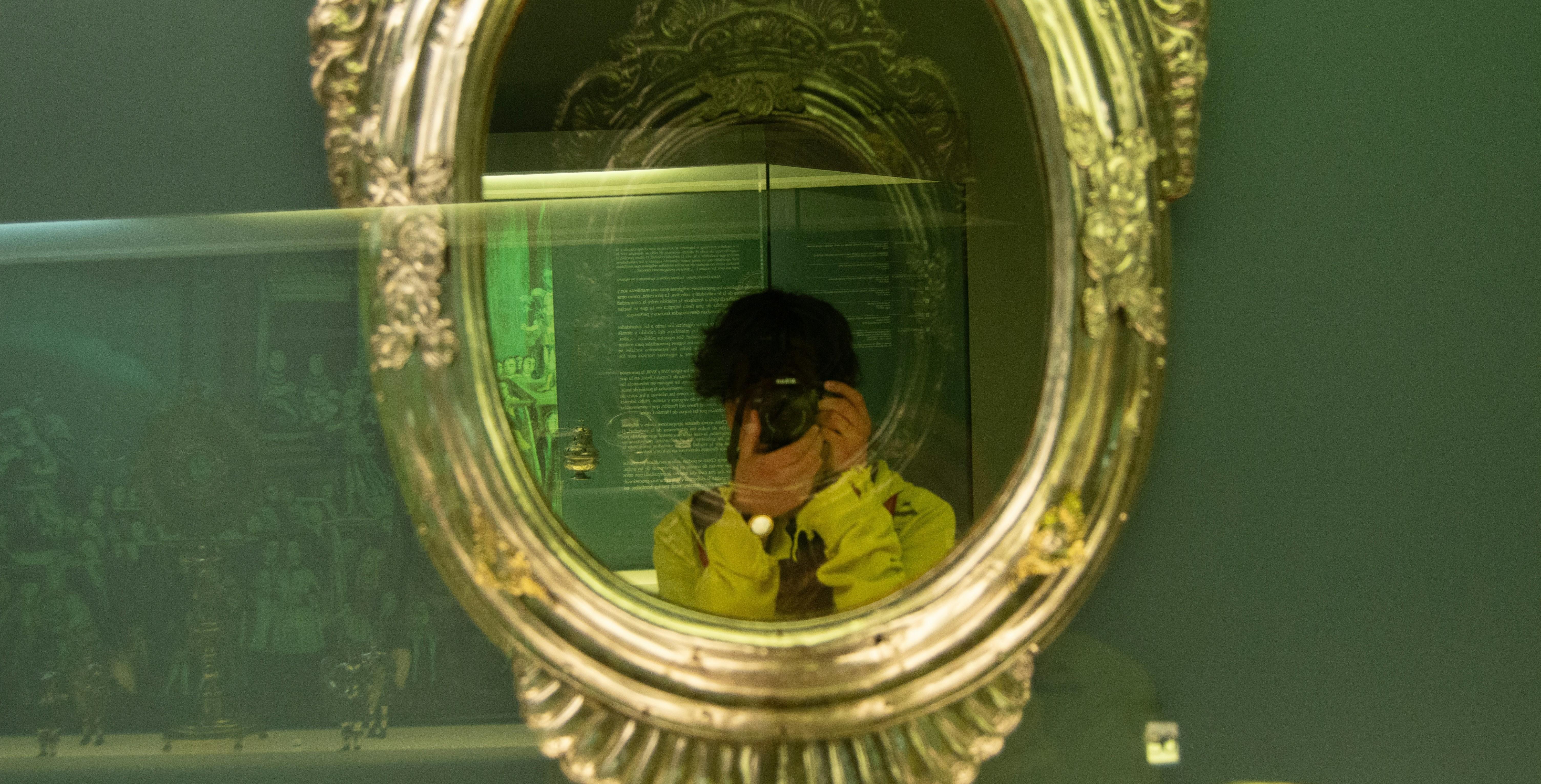 young man taking a picture of himself in a mirror