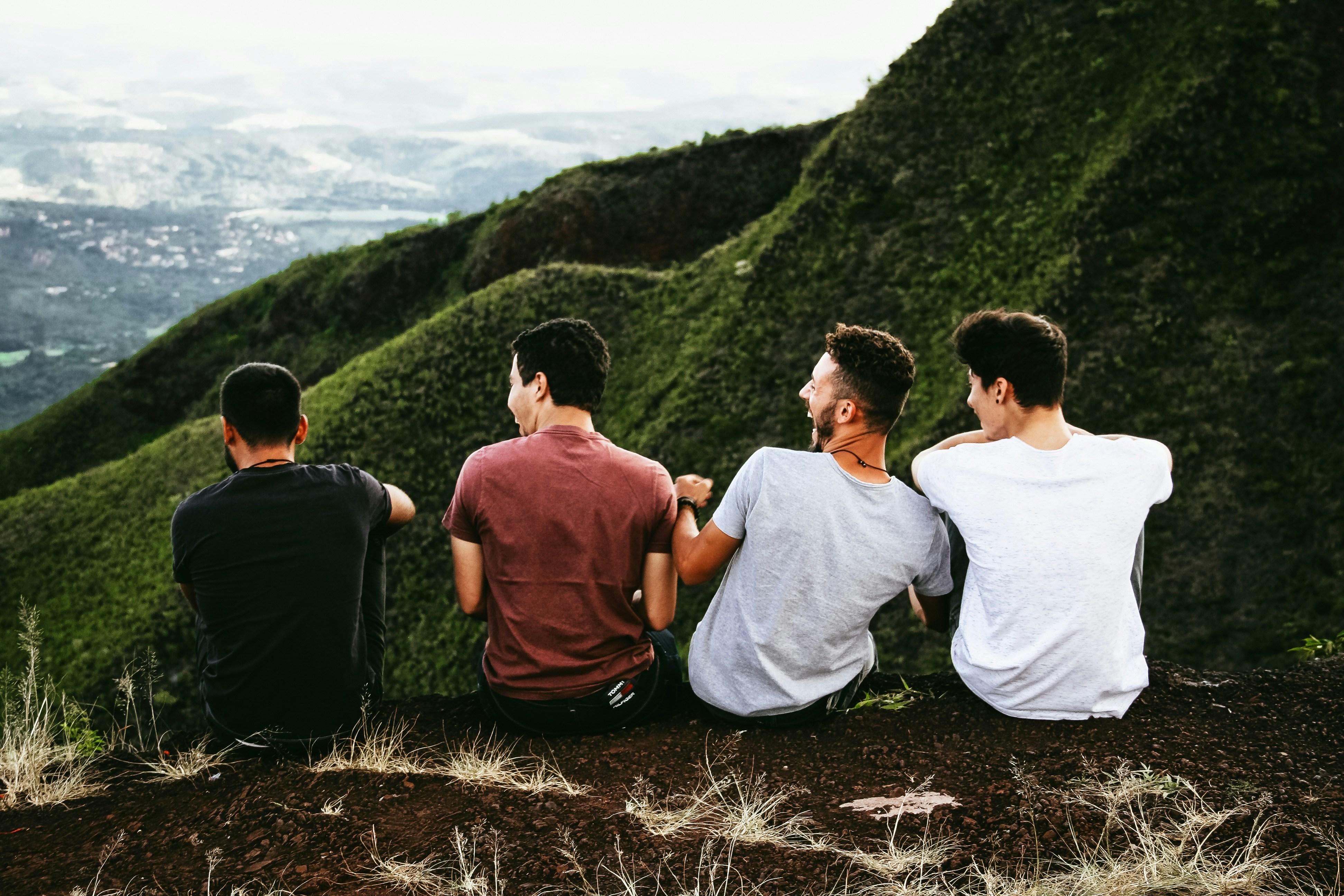 Four boys looking out over a mountain.