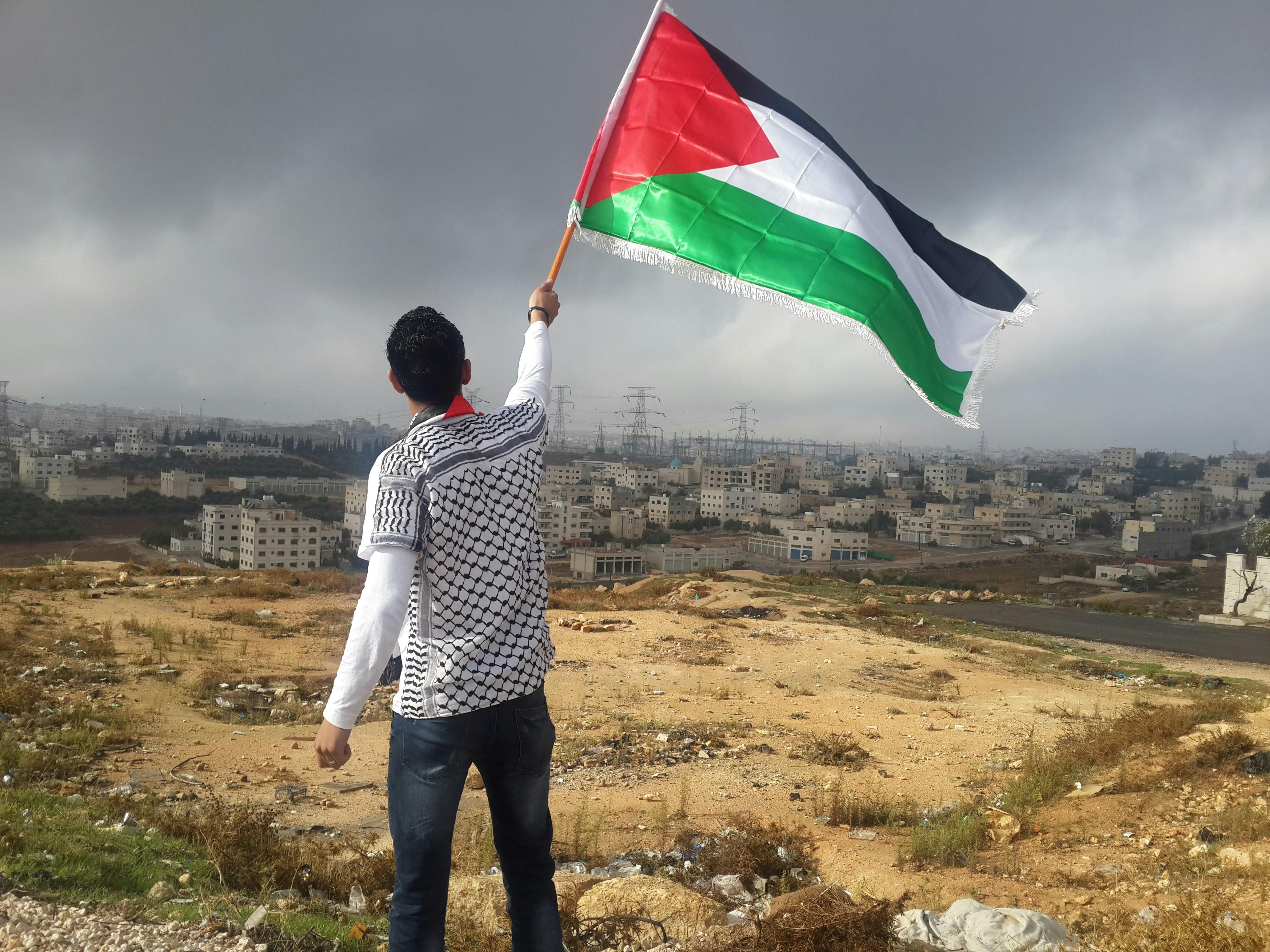 A man waving a Palestinian flag. 