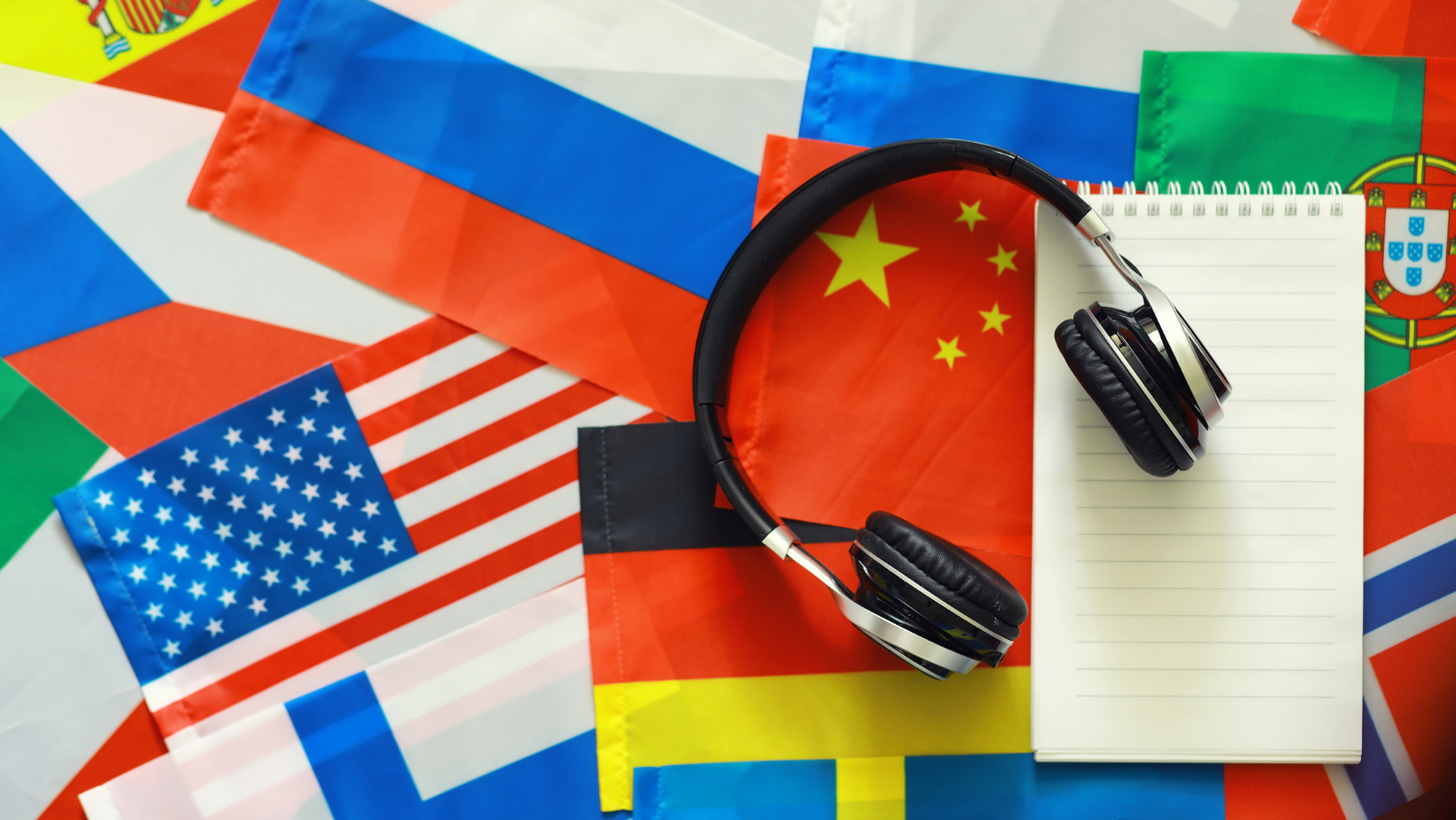 Flags with headphones and a notepad