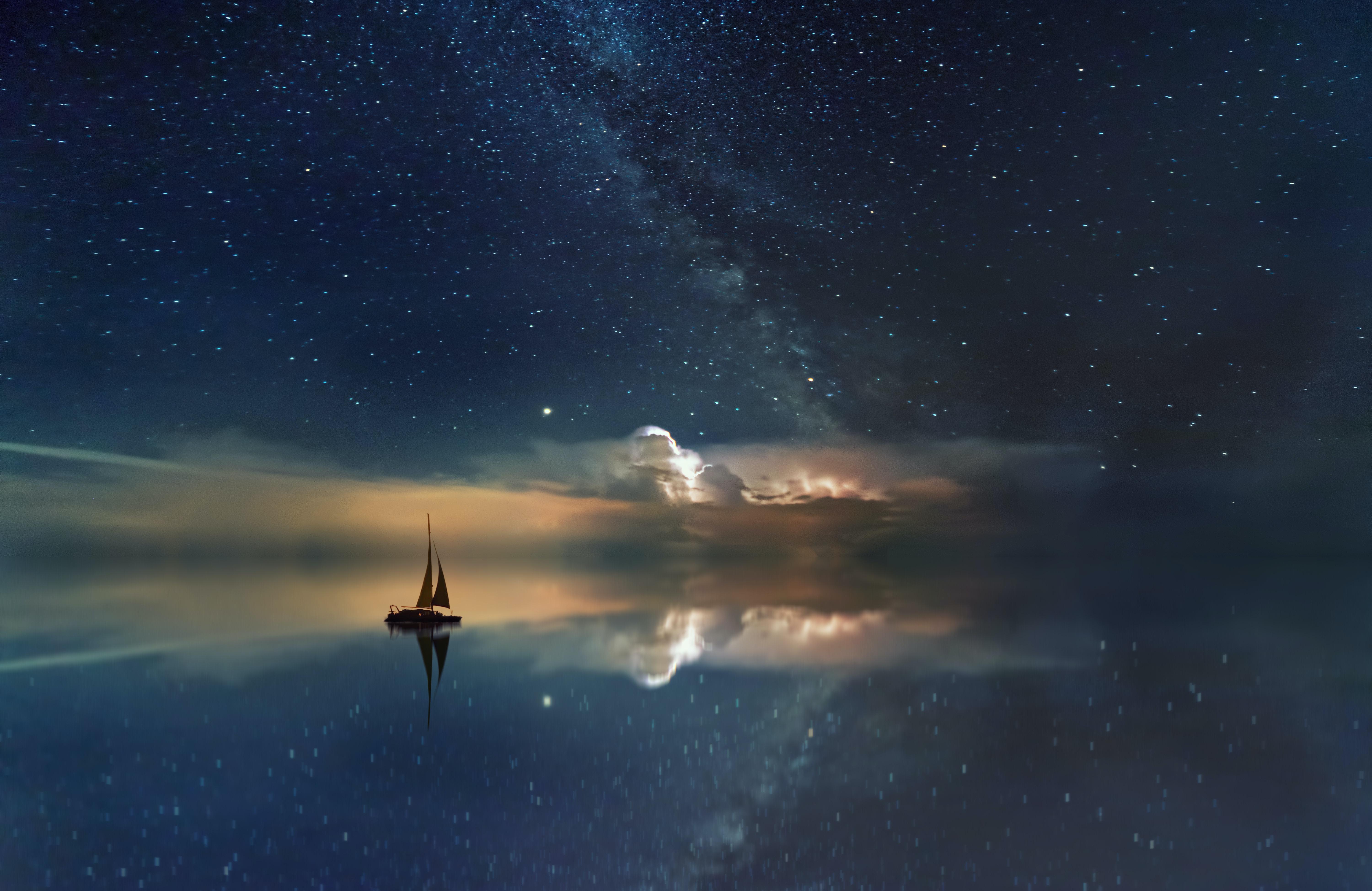Sailboat sailing through the night