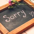 "sorry" written on a chalkboard