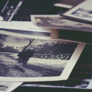 pile of old photographs on a table