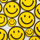 many yellow smiley faces on a white background