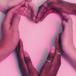 a group of hands forming the shape of a heart on a pink background
