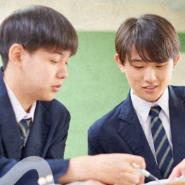 Two teen students sitting at a desk studying together