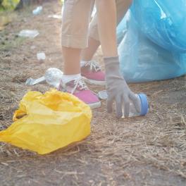 person picking up a piece of trash