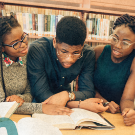 group of students looking at a book