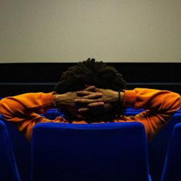 person sitting in the movie theater alone