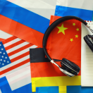Flags with headphones and a notepad