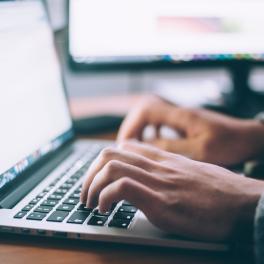 person typing on a laptop