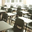 a group of empty desks in a classroom