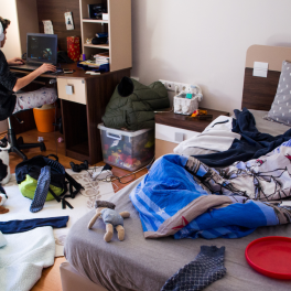 Teenager gaming in a messy room
