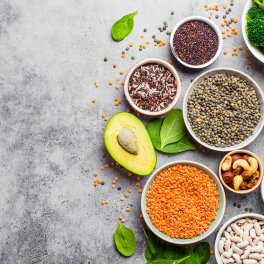 an assortment of vegetarian foods on a gray background