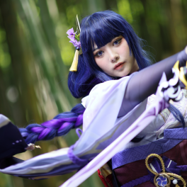 a woman wearing a purple cosplay costume with a sword