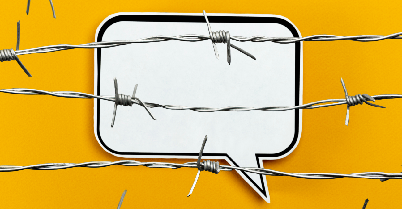 a speech bubble behind barbed wire on a yellow background