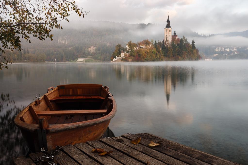 a boat on the water with a castle in the background