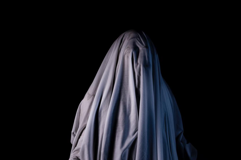 person standing with a cloth on their head