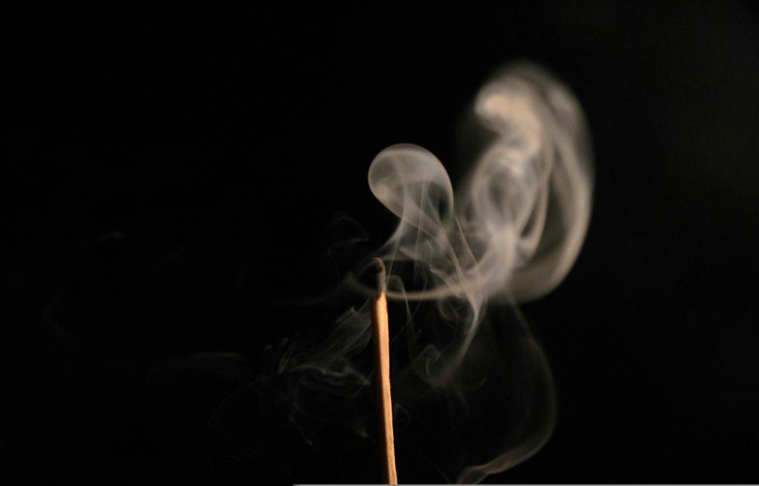 blown out match on a black background