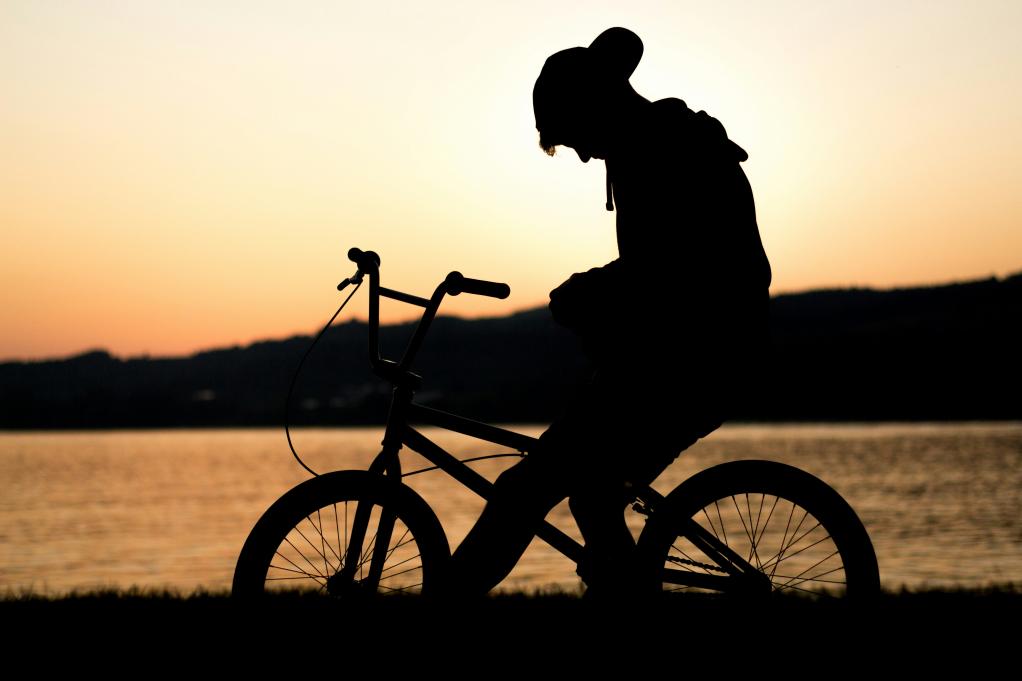 young boy sitting on a bike