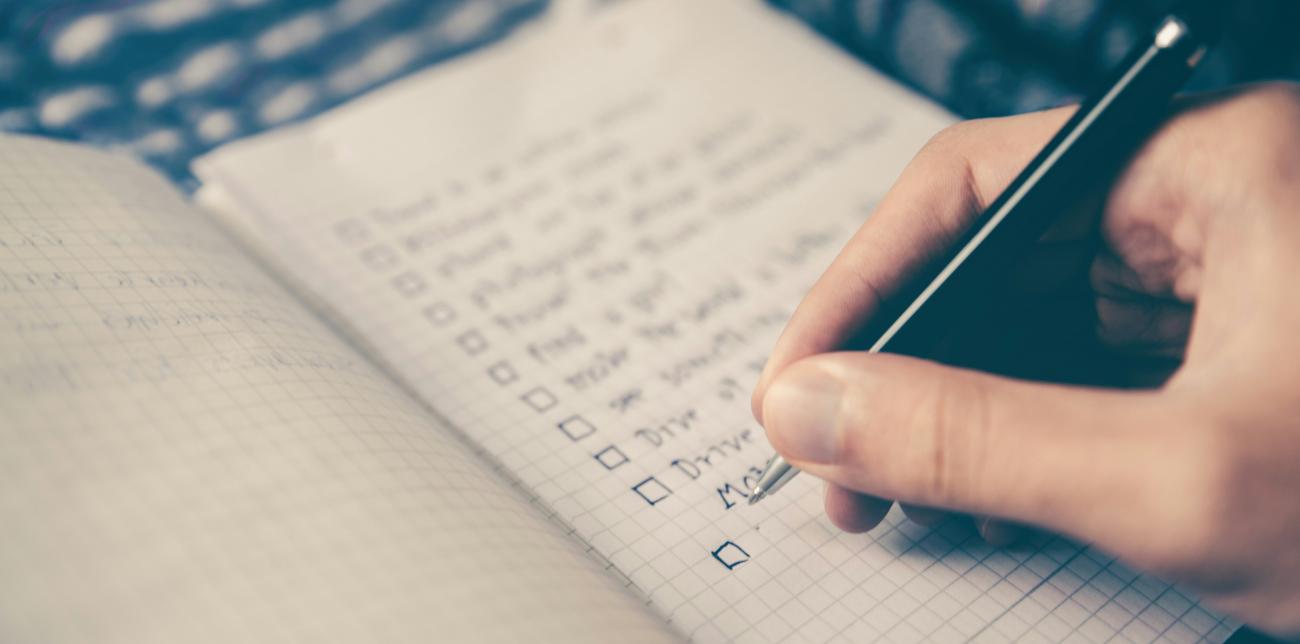 person writing a to do list