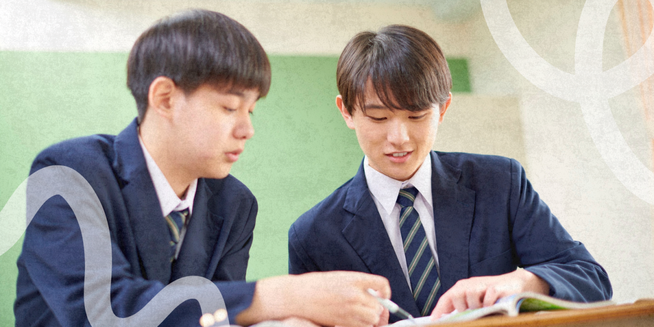 Two teen students sitting at a desk studying together